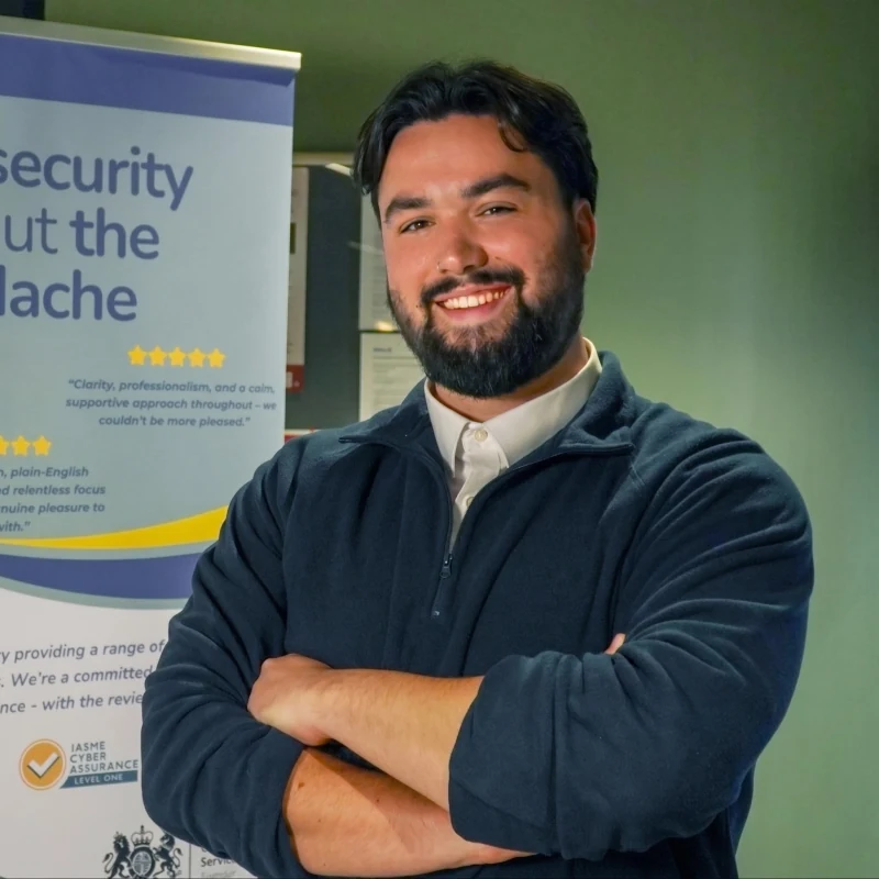 Savva Pistolas smiling with his arms folded